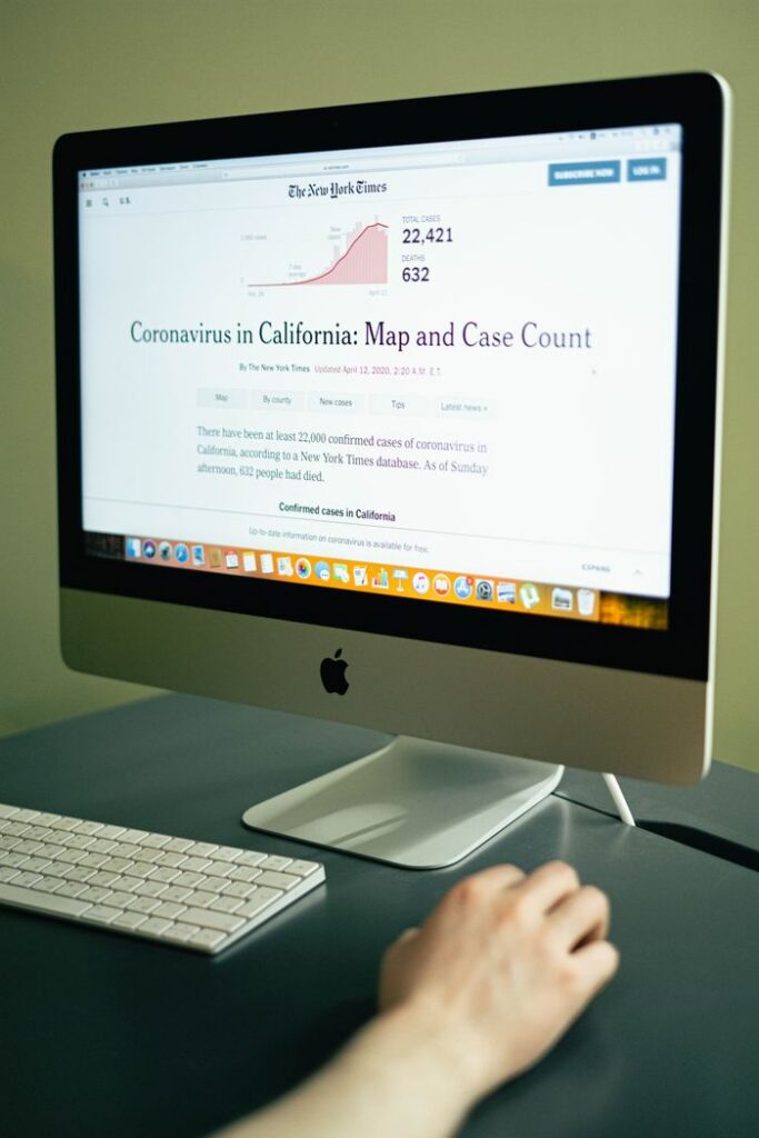 A computer displaying coronavirus case numbers in California on a news website.